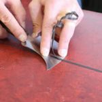 Raspado manual del cordón de soldadura en pisos vinílicos utilizando el cuchillo media luna