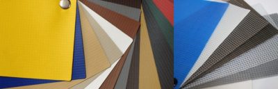 Muestras de lonas plásticas en diferentes colores y acabados, fabricadas en PVC y otros termoplásticos, para múltiples aplicaciones industriales y comerciales