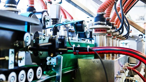 Imagen de línea de producción industrial con equipos Leister aplicando calor en procesos automatizados para plásticos
