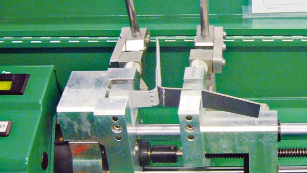 Es simple, con el EXAMO USB. Este dispositivo consiste básicamente en una unidad de control y medición, mordazas de fijación del cupón de prueba y un mecanismo de movimiento de la mordaza. Se debe definir una velocidad de prueba, por ejemplo, la velocidad con la que las mordazas se separan, haciendo que la muestra de prueba sea sometida a esfuerzo por elongación progresiva. Al final de la prueba, de tipo destructivo, a través de la pantalla digital, es posible visualizar la carga máxima (F pico) y la carga de rotura (F rotura) medidas junto con los valores de elongación correspondientes